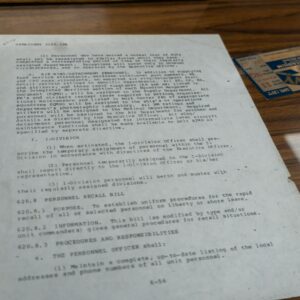 Old document with text and small card.